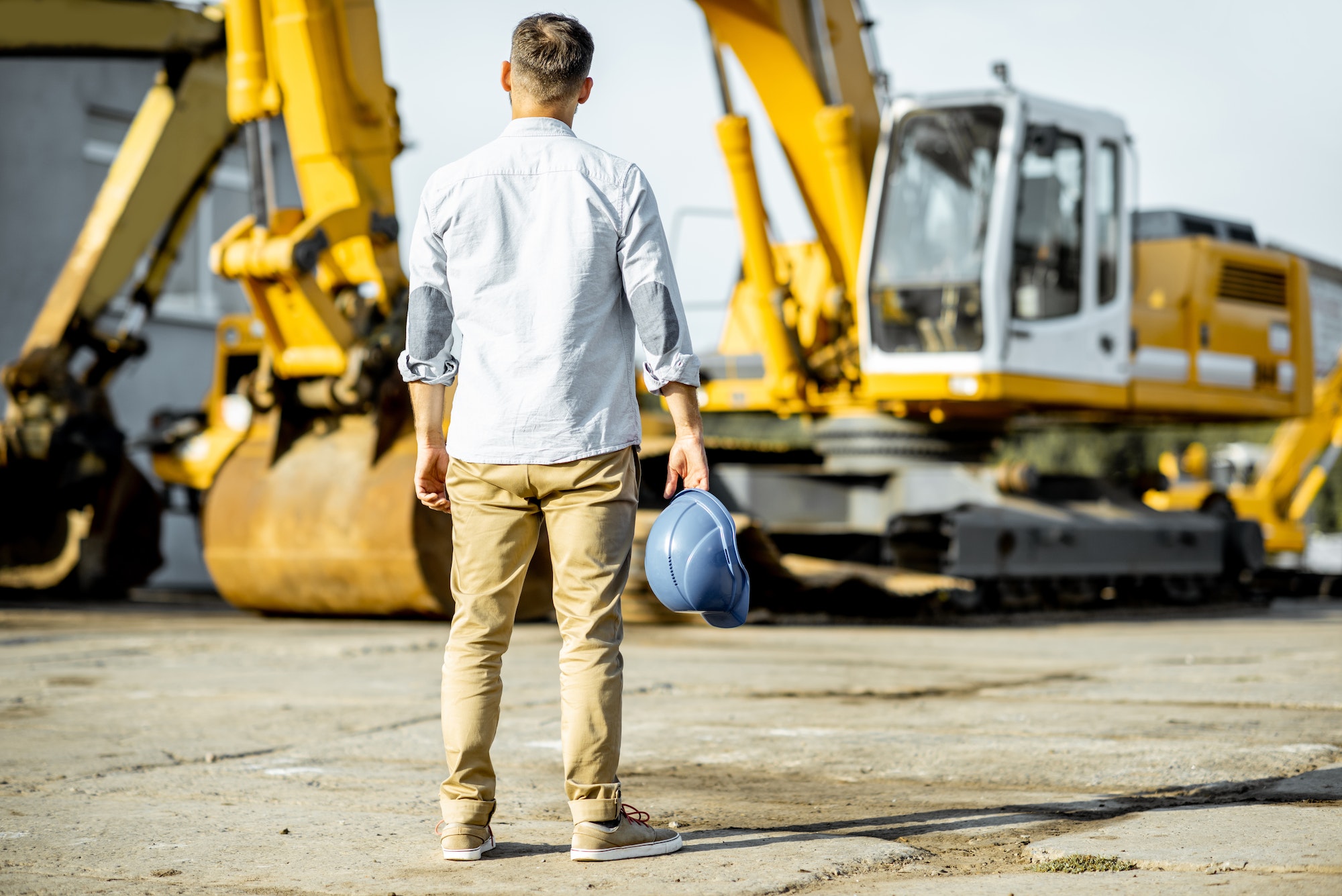 Builder at the shop with heavy machinery