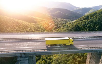 Yellow cargo delivery truck drive on highway aerial view